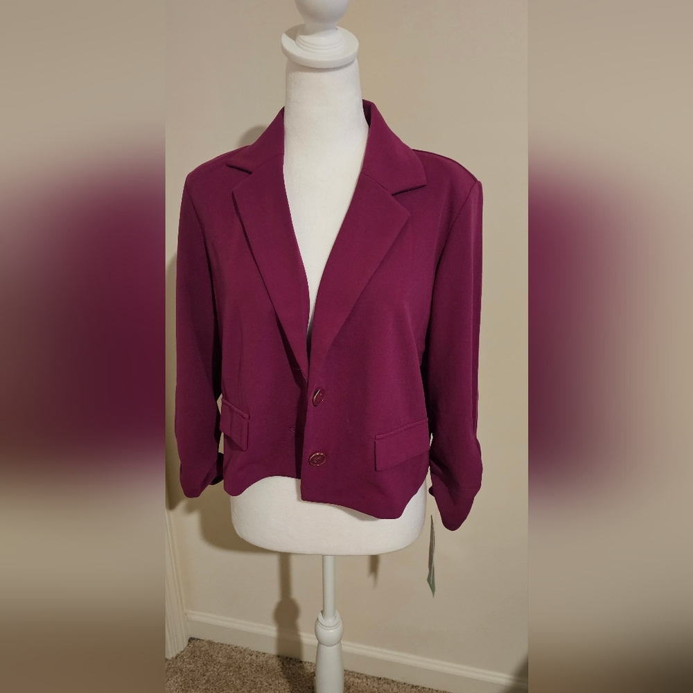 Ladies purple/burgundy blazer with elastic design on both hands of blazer.